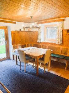 a dining room with a wooden table and chairs at Ferienwohnung Steinberger in Fügenberg