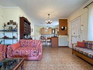 a living room with a pink couch and a kitchen at Private Paradise in Nikiti in Nikiti