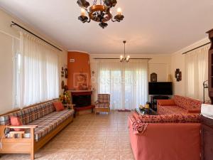 a living room with two couches and a tv at Private Paradise in Nikiti in Nikiti