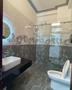 a bathroom with a toilet and a sink at Dalat Friendly Fun in Da Lat +8 photos