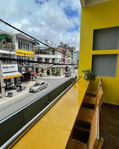 a view of a city street from a yellow building at Dalat Friendly Fun in Da Lat