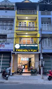 a yellow building with a fidelity run sign on it at Dalat Friendly Fun in Da Lat