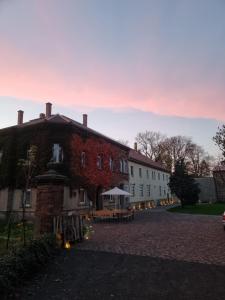 a large brick building with a table in front of it at Designwohnung auf Gutshof mit Sauna zw. L/DD in Mügeln