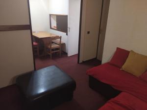 a living room with a couch and a table at appartement au pied des pistes in Valmorel