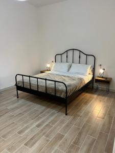 Schlafzimmer mit einem Bett und Holzboden in der Unterkunft Le Tre Borghesi in Parma