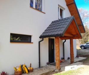 a porch with a roof on a house at Sowinka in Lutowiska