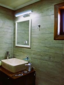 a bathroom with a sink and a mirror at WANNAQUEROS SUITES in Guanaqueros