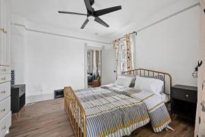 a bedroom with a bed and a ceiling fan at Center of Little Italy #4 in Cleveland