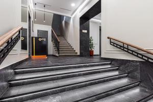 a staircase in a building with black marble floors at Kievinn in Kyiv