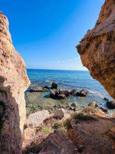 a view of the ocean from a rocky beach at Montalbano House. Be our guest. in Sciacca