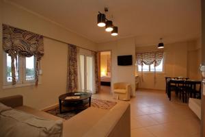 a living room with a couch and a table at Palatino Rooms & Apartments in Tripoli