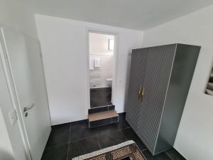 a bathroom with a shower and a toilet and a door at Roggendorf Zimmervermietung in Roggendorf