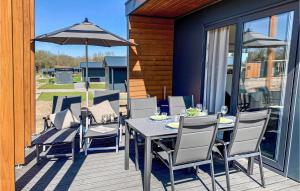 a table and chairs with an umbrella on a deck at 2 Bedroom Cozy Home In Ssel in Süsel