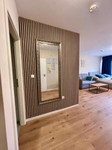 a mirror on a wall in a living room at Apartment Beethoven by Aux Property in Augsburg
