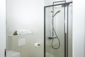 a bathroom with a shower with a glass door at Ferienhaus Kaimt Zell in Zell an der Mosel