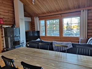 a dining room with a large wooden table and chairs at Topin Mestari Ruka in Ruka +28 photos