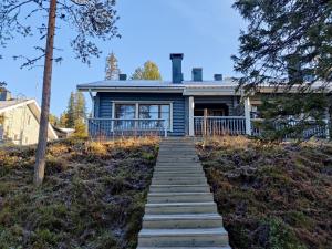 a blue house with a staircase leading up to it at Topin Mestari Ruka in Ruka