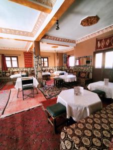 a restaurant with tables and chairs in a room at auberge restaurant tizgui in Tinerhir +87 photos