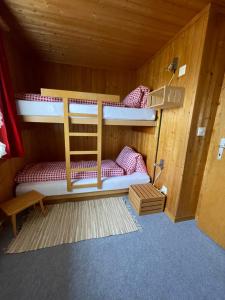 a bunk bed room with two bunk beds in it at Chalet Chutzli in Axalp