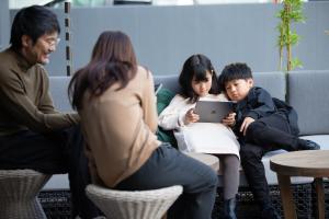a group of people sitting on a couch with a tablet at fav KAGOSHIMA CHUO in Kagoshima +38 photos