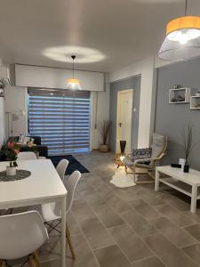 a living room with a couch and a table and chairs at Joanna Court rooms in Larnaka