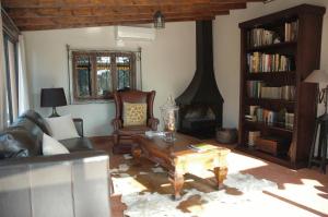 a living room with a couch and a fireplace at Hotel Mas El Cuquello in Els Ibarsos