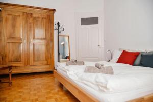 a bedroom with a large white bed with towels on it at Casa Celio Ambrì in Quinto