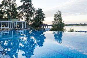 a swimming pool with a view of a body of water at Perlyna Resort in Sokirno