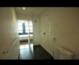 a bathroom with a shower stall and a toilet at Fountain Suites Aparthotel - PRIVATE in Cape Town