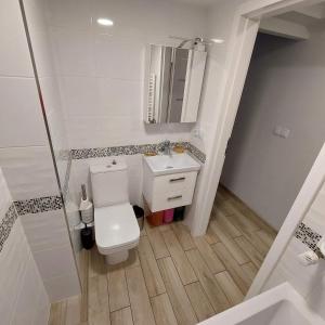 a bathroom with a toilet and a sink and a shower at Apartament przy kładce in Przemyśl +1 photo