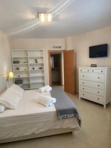 1 dormitorio con 1 cama con cómoda y TV en Apartamento CyM, en Ronda