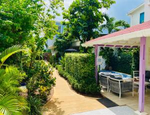 a patio with a table and chairs next to a house at Summer House Inn San Andres in San Andrés