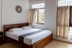 Rúm í herbergi á Greenscape Colombo