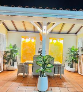 Villa Paradis في لو-فرانسوا: فناء مع طاولة وكراسي في منزل