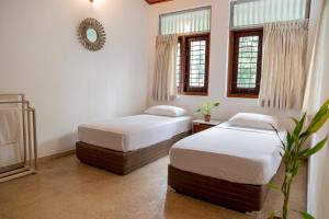 Rúm í herbergi á Greenscape Colombo