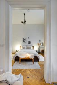 a bedroom with a large bed and a table at Felsőerdősor Residence in Budapest