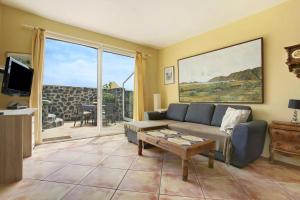 a living room with a couch and a table at Casa Verde in Teguise