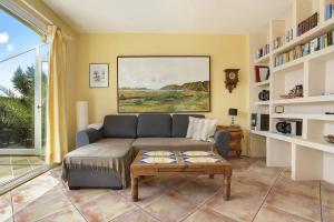 a living room with a couch and a table at Casa Verde in Teguise