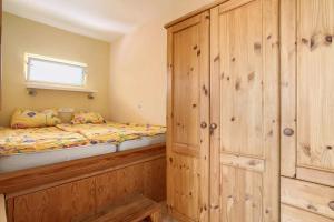 a bedroom with a bed and a wooden cabinet at Casa Verde in Teguise