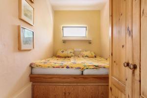 a small bed in a small room with a window at Casa Verde in Teguise