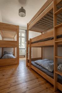 two bunk beds in a room with wooden floors at Zeitreise: Wohnen im Herrenhaus genau zw. L u. DD in Mügeln