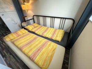 a bed with two blankets and two pillows on it at Seemannsbraut in Kellenhusen