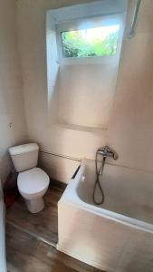 a small bathroom with a toilet and a window at Guest House - Гостевой частный дом in Dnipro