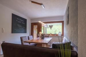 a dining room with a wooden table and chairs at Apart Leitner in Lermoos +48 photos