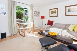 a living room with a couch and a table at Walking distance to racecourse and city centre in York