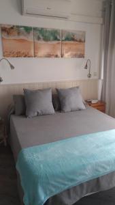 a bedroom with a bed with two pillows at Brisa de Mar in Empuriabrava
