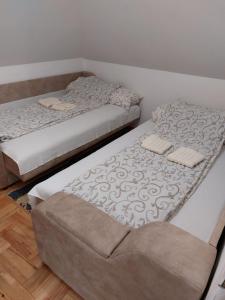 two beds sitting next to each other in a room at Vila Jelena Divčibare in Divčibare