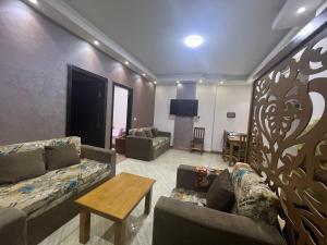 a living room with two couches and a table at Compound cecelia families only in Hurghada