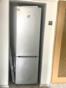 a refrigerator in a room with a door open at CASA DIEGO in Bucharest