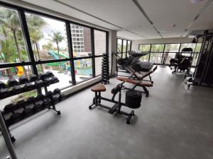 a fitness room with a gym with equipment and windows at Ap particular 1001 ou 1201 no Salinas Premium Resort in Salinópolis